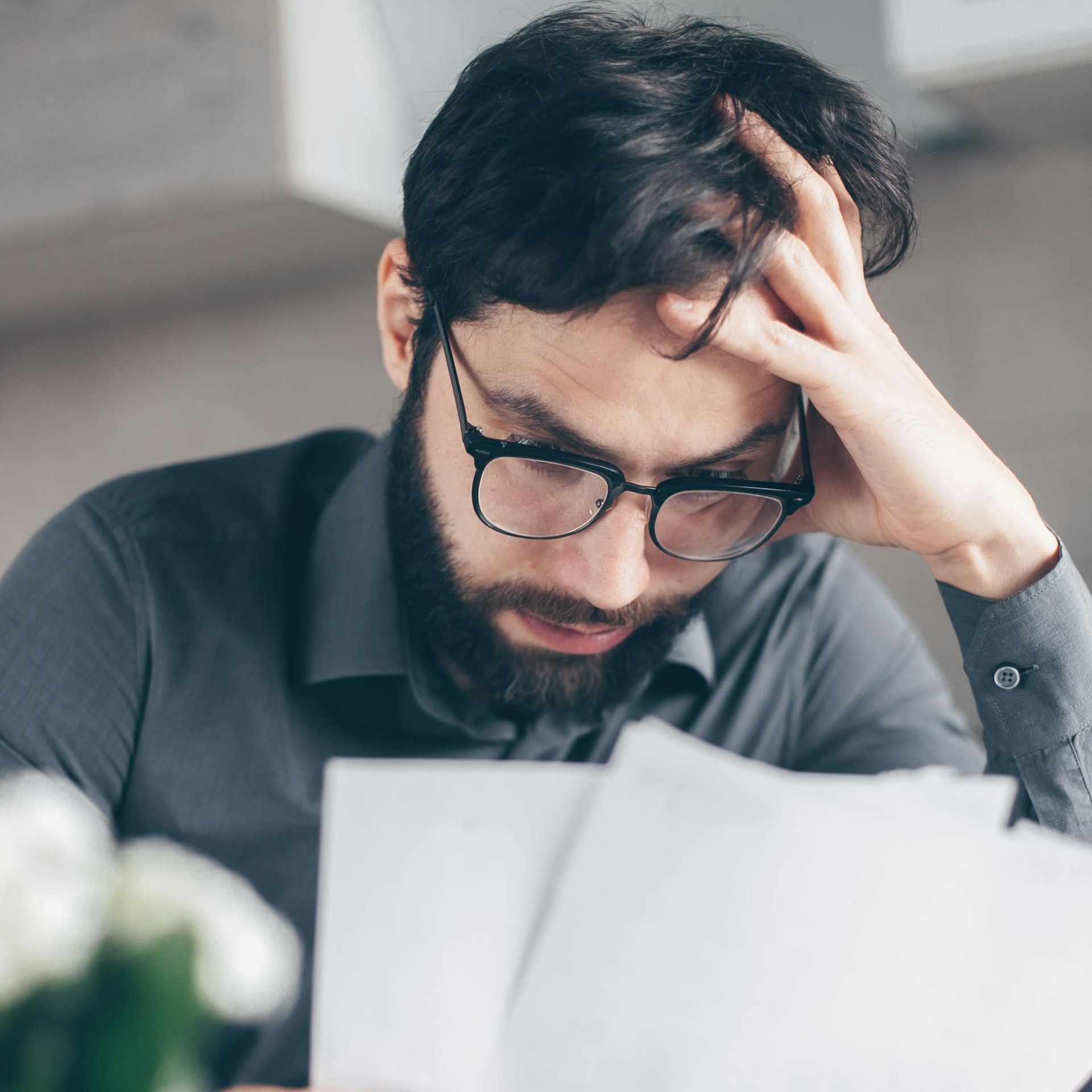 man looking at a high electric bill
